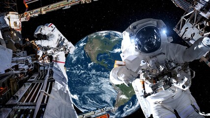 Astronaut spaceman do spacewalk while working for spaceflight mission at space station . Astronaut wear full spacesuit for operation . Elements of this image furnished by NASA space astronaut photos . © InfiniteFlow