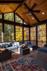 Cozy screened porch with contemporary furniture and flower bouquet in a vase, autumn leaves and...