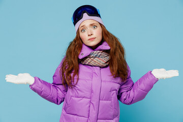 Skier confused doubtful woman in warm purple padded windbreaker jacket ski goggles mask spend...
