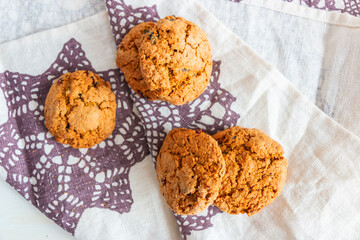 Oatmeal cookies on white background and linen towel with purple snowflakes
