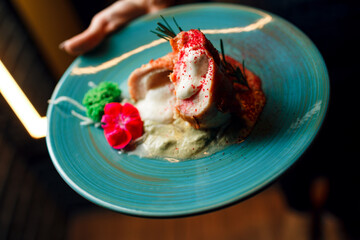 chicken breast on a blue plate on a dark background close-up