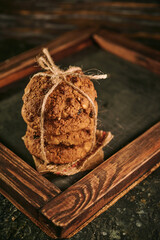 Pile of oat cookies on wooden table, close-up, selective focus