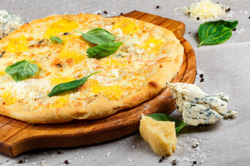 Cheese pizza on a wooden board