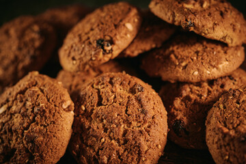 Pile of oat cookies on wooden table, close-up, selective focus