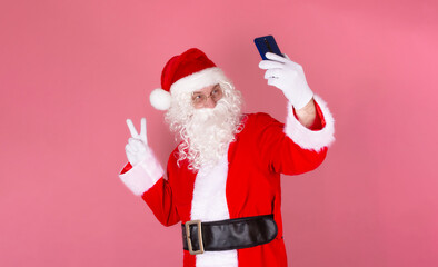 Stylish adult man in Santa Claus costume to make a Christmas selfie image-sign , 