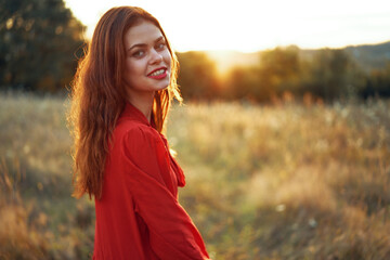 woman in red dress in the field walk freedom landscape