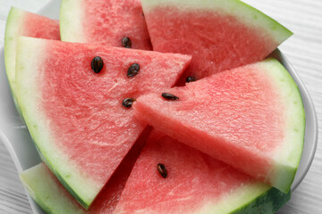 Delicious fresh watermelon slices on white wooden table, closeup