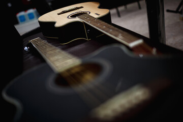 Fototapeta na wymiar two acoustic guitars on a black background