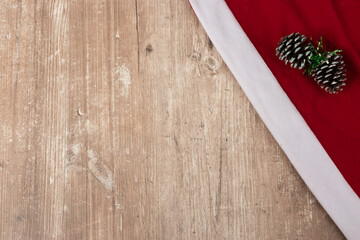 wooden textured background with empty space and corner red fabric with christmas ornament, style and elegance