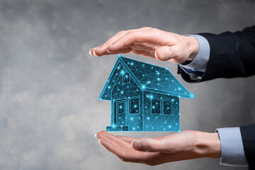 Man hold low polygon.Real estate concept, businessman holding a house icon.House on Hand.Property insurance and security concept. Protecting gesture of man and symbol of house