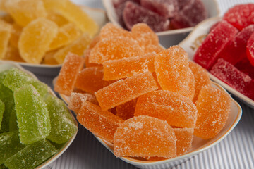 Dessert marmalade in the form of lemon and orange slices. The sweetness of jelly candy.