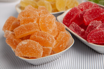 Dessert marmalade in the form of lemon and orange slices. The sweetness of jelly candy.