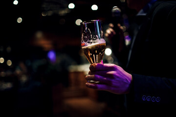 Closeup of a man holding on to his glass