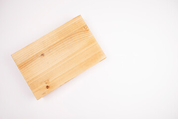 A block of wood lies on a white background. The choice of wood for furniture. The choice of wood for renovation. House and apartment renovation.