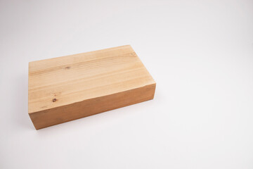 Block of wood lies on a white background. The choice of wood for furniture. The choice of wood for renovation. House and apartment renovation.
