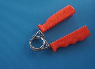 hand expander for sports at home on a blue background