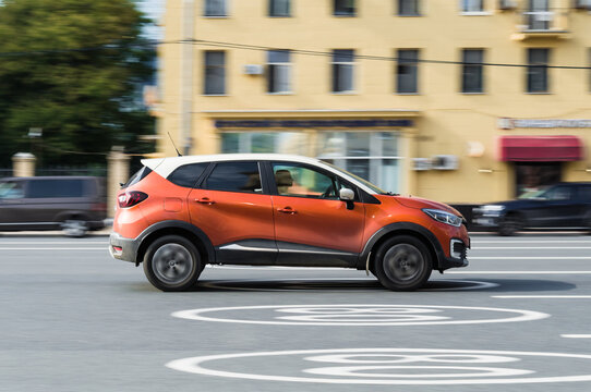 Renault Captur First generation crossover driving along the street in city with blurred background