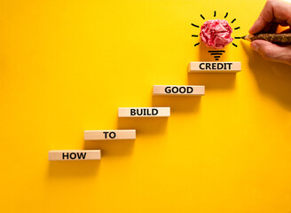 Build good credit symbol. Wooden blocks, words How to build good credit. Beautiful beautiful yellow...