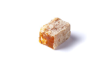 Turkish delight isolated on white background. Lokum covered coconut flakes. Fruit jelly candy with hazelnut. close up