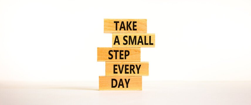 Take a small step every day symbol. Wooden blocks with words Take a small step every day. Beautiful white background, copy space. Business, step every day concept.