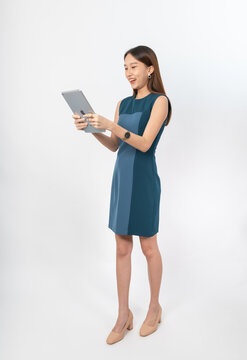 Photograph of a young, beautiful and sexy asian Thai lady model in professional business attire with a tablet on hand