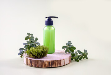 container with cosmetics on a wooden board, cranberry branches and moss.natural cosmetics