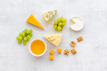 Set of different types of cheese with grapes. Dairy products flat lay