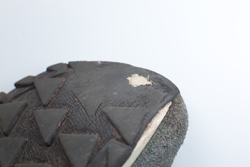 Close up Torn gray leather sneakers. Leather shoes. Shoe repair concept.