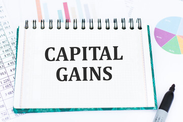 Paper with text Capital Gains on a financial table. Financial and concept photo