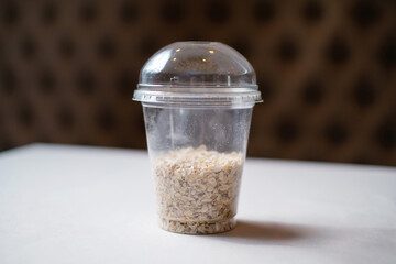 Healthy takeaway food. Oatmeal in a transparent plastic container.