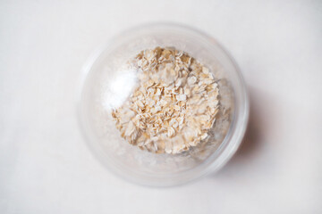Healthy takeaway food. Oatmeal in a transparent plastic container. Top view.