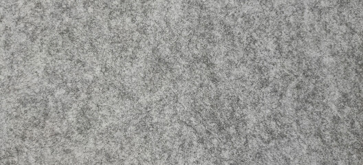 Fototapeta na wymiar grainy gray background in the form of a stone or material surface. 