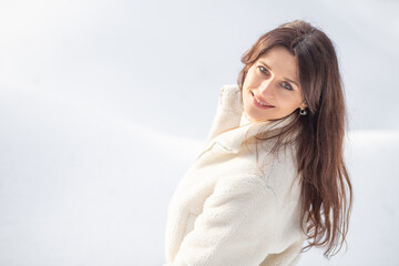 Naklejka premium Portrait of a beautiful European woman in a winter forest, the woman has long hair, celebrating Christmas and New Year. 