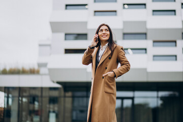 Young business woman using phone