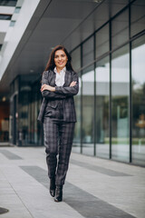 Young business woman in classy suit by office center