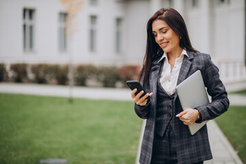 Young business woman in classy suit by office center