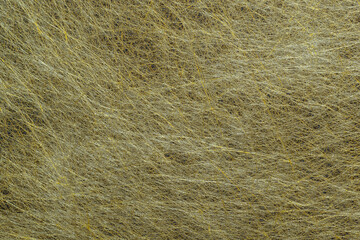 Ornamental interlining fibers visible to the naked eye. A sheet of golden decorative non-woven fabric for background