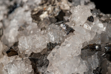Macro mineral stone Stibnite quartz on a black background