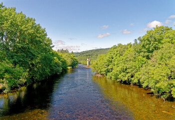 Fototapeta na wymiar View of the Caledonian Canal where it enters Loch Ness at Fort Augustus