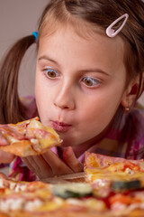 Funny portrait of young beautiful attractive girl eat street food pizza. Selective focus on eyes. Vertical image.