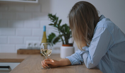 Woman suffering from depression and drinking alcohol.