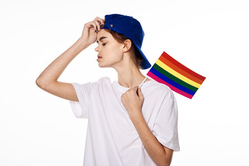 girl in white t-shirt lgbt flag transgender posing light background