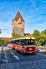 Fototapeta na wymiar Schuldturm tower with city train on the bridge in Nuremberg, Germany
