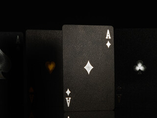 Obraz premium Casino, online casino background. Black poker cards with white and gold stamping on a black background. Gambling, poker, gambling business, game strategy, risk, cash flows.