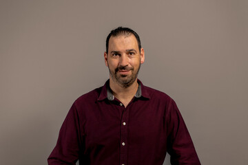 Portrait of proud mid man isolated on grey background