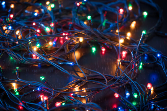 Dark festive background with wires of electric garland