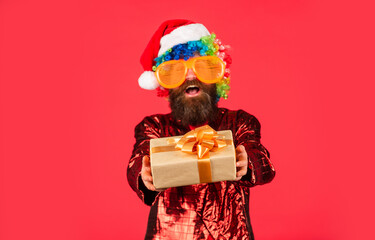 for you. hipster enjoy the holiday. man in santa hat await christmas present. new year shopping idea concept. morning before Xmas. bearded man in party glasses. ready for party celebration