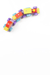 Wooden toy train with colorful blocks on white background. Montessori toys for babies and toddlers. Early education, leisure games for children. Top view