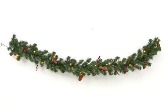green garland with lights and pine cones