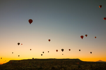 Hot air balloons at sunrise. Sunrise in Cappadocia with hot air balloons on sky